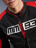 Alpinestars MM93 T-SPS Air V2 Jacket, Motorcycle Jacket, Black Bright Red and White, close-up of chest featuring large white MM93 logo, red 'Alpinestars Protects' and 'Tech-Air Ready' zipper pull, tech mesh fabric texture