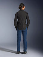 Woman Stella Aeroshell Airflow Jacket, Black Anthracite, back view on a model, featuring lightweight softshell chassis with laser-perforated mesh panels, extended rear profile for coverage, sport riding fit, paired with blue jeans