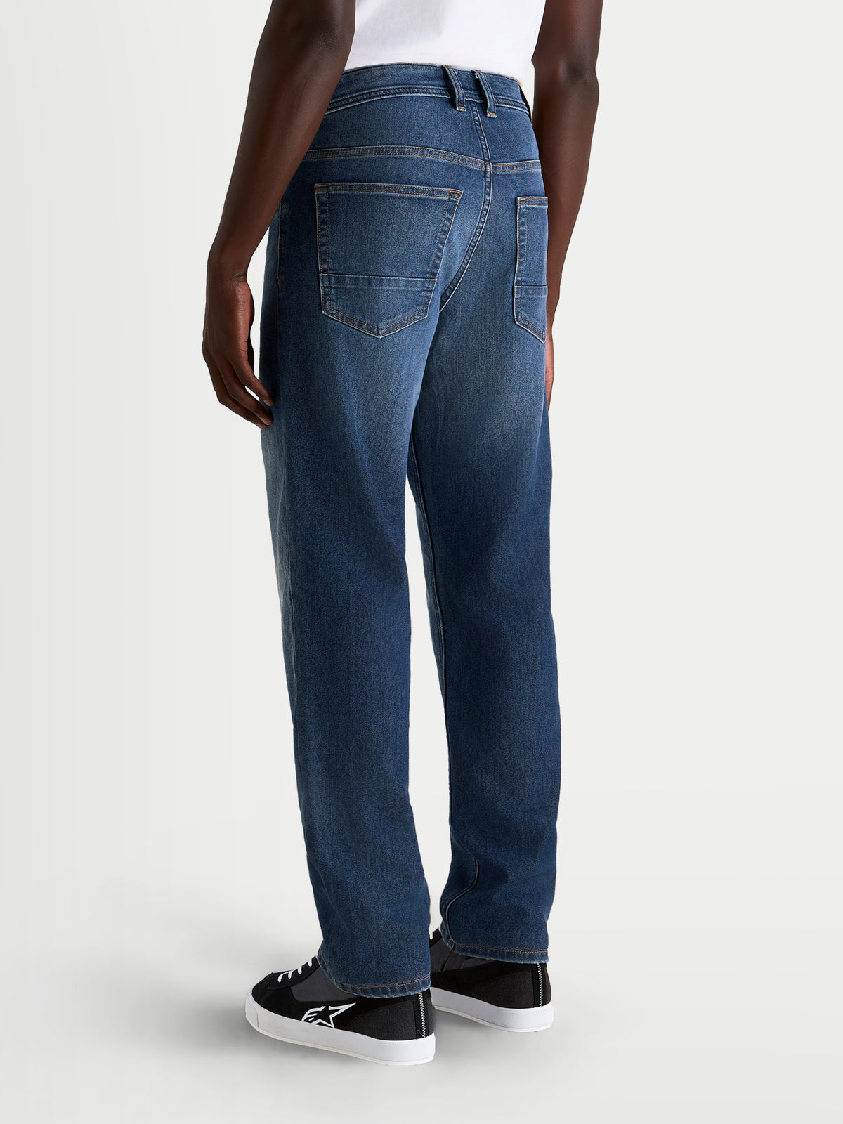 Alpinestars Flex Ast 8 Denim Spodnie, męskie jeansy motocyklowe urban w kolorze niebieskim, widok z tyłu na model prezentujący jednowarstwową konstrukcję z elastycznego denimu, układ z pięcioma kieszeniami i prosty krój