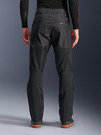 Alpinestars C-1 Air Pants, back view, Black, urban textile motorcycle pants featuring large tech mesh panels on the back of the legs for ventilation, clean design with subtle branding, worn with a black base layer and casual riding shoes.