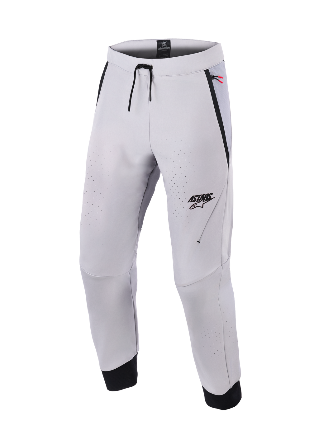 Alpinestars Aeroshell Airflow Pants, spodnie motocyklowe w kolorze Mid Gray, wyposażone w laserowo perforowane strefy wentylacyjne, logo ASTARS na lewym udzie, ściągacz w pasie i czarne mankiety na kostkach, techniczna konstrukcja softshell do jazdy sportowej i miejskiej