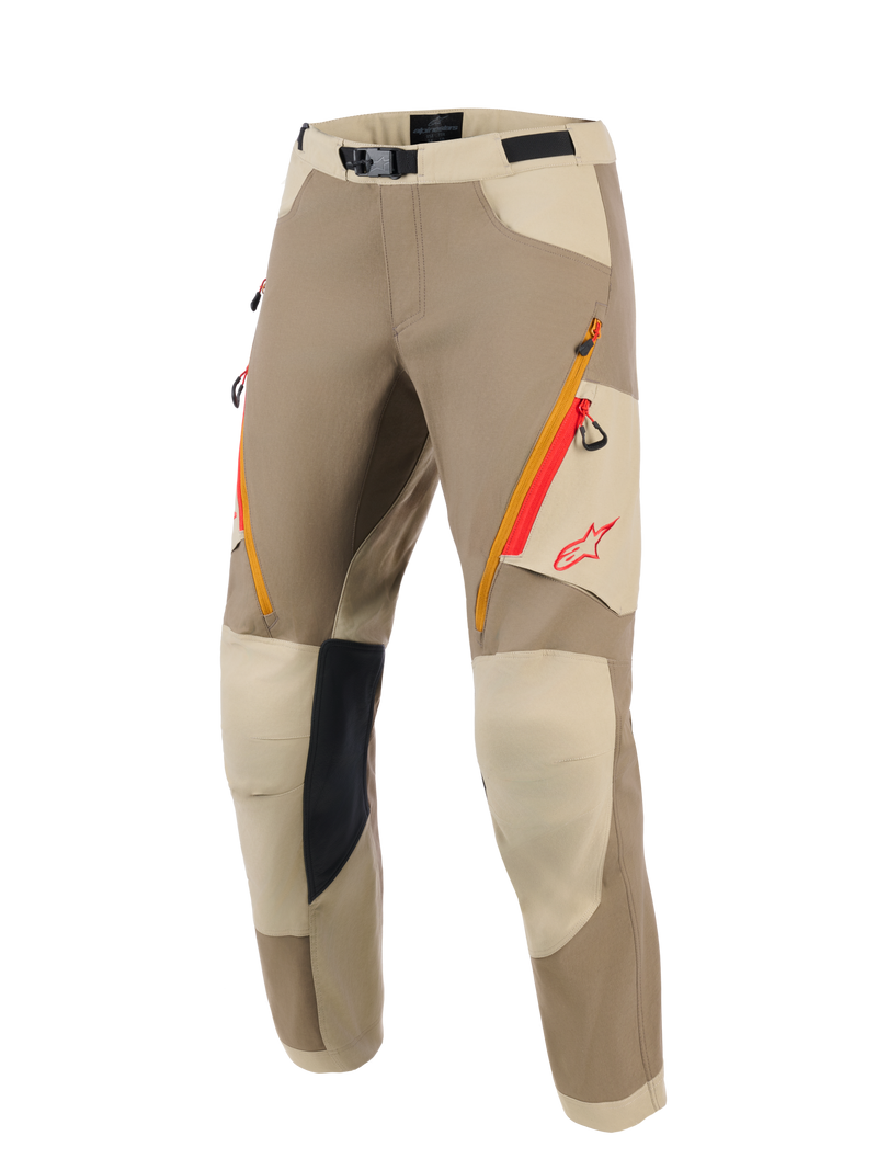 Alpinestars Maxdura Dual Pants, Adventure Motorcycle Pants, Walnut and Aluminum tan colorway, featuring orange and red zippered thigh pockets, light beige reinforced knee panels with black inner grip, and red Alpinestars logo, designed for dual-sport riding