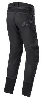 Alpinestars SP Pro Pants, techniczne sportowe spodnie motocyklowe w kolorze czarnym, widok z tyłu pokazujący zamek do łączenia w pasie, elastyczne wstawki RIDEKNIT na tylnym karczku i łydkach oraz subtelne logo.