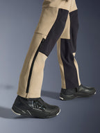 Alpinestars Woman Stella Flex-AST Explorer Pants, Motorcycle Adventure Pants, Sand and Black, close-up view of the lower legs and ankles featuring a long side zipper and black reinforcement panels, worn with black Alpinestars riding shoes.