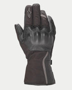 Alpinestars Stella Tourer W-7 Drystar® Gloves, damskie zimowe rękawice motocyklowe, czarne, konstrukcja ze skóry i softshellu, twarde ochraniacze kostek pokryte skórą, srebrne odblaskowe akcenty, logo Alpinestars na palcu