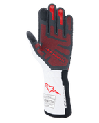 Rękawice Alpinestars Tech-1 ZX V4, samochodowe rękawice wyścigowe, czarno-biało-czerwone, widok od strony dłoni z czerwonym silikonowym wzorem chwytnym 3D, biały mankiet z czerwonym logo Alpinestars oraz etykietami certyfikacji FIA i SFI