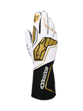 Alpinestars Tech-1 KX V4 Gloves, rękawice kartingowe, biało-czarne ze złotymi akcentami, złote logo gwiazdy na palcu wskazującym i duże złote wzory geometryczne na grzbiecie, oddychająca konstrukcja z siateczki, czarny mankiet z białym logo marki, ergonomiczny design dla sportów motorowych