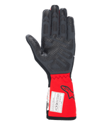 Alpinestars Tech-1 Race V4 Gloves, samochodowe rękawice wyścigowe, czarno-czerwone, widok od strony dłoni podkreślający silikonowe wzory przyczepne na palcach i dłoni, przedłużony czerwony mankiet z logo Alpinestars i etykietą certyfikacji FIA, profesjonalny sprzęt do sportów motorowych