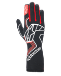 Alpinestars Tech-1 Race V4 Gloves, rękawice wyścigowe, czarne z czerwonymi i białymi akcentami, duże białe logo gwiazdy na wierzchu dłoni, czerwone kliny między palcami, białe logo na przedłużonym mankiecie i geometryczne wzory