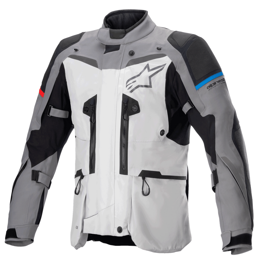 Alpinestars Boulder GORE-TEX Jacket, motocyklowa kurtka turystyczna adventure, ciemnoszara i jasnoszara, liczne zamki wentylacyjne, wzmocnione panele na ramionach i łokciach z niebieskimi i czerwonymi akcentami, duże logo Alpinestars na klatce piersiowej, zaawansowana techniczna odzież wodoodporna