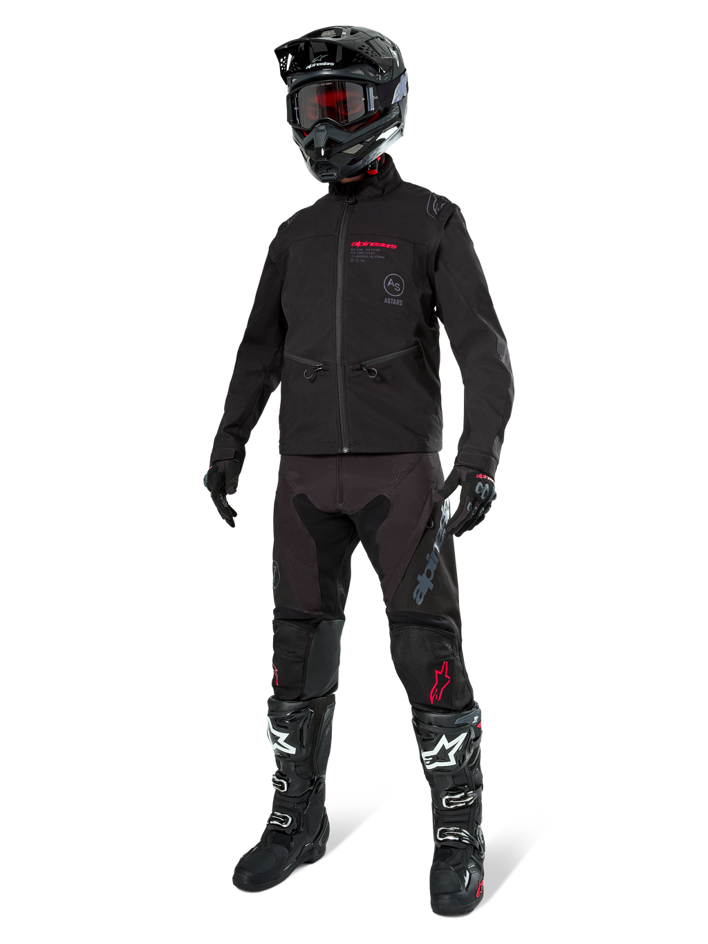 Kurtka Alpinestars Lite-Dura Softshell, czarna, zaprezentowana na manekinie w kompletnym zestawie off-road z czarnymi spodniami, czarno-białymi butami i czarnym kaskiem z czerwonymi goglami, profesjonalna odzież motocrossowa i enduro.
