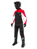 Motocross rider wearing the Alpinestars Lite-Dura Softshell Jacket in Black, Bright Red, and White, featuring a black body with red and white sleeves, paired with black pants, a black helmet with red goggles, and black and white boots, complete off-road racing outfit.