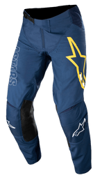 Alpinestars Techstar Phantom Pants, spodnie motocrossowe, ciemnoniebieskie z żółtymi i białymi akcentami, czarne skórzane panele na kolanach, duże żółte logo gwiazdy na udzie, białe oznaczenia ASTARS, wytrzymała tkanina stretch rip-stop do wyścigów off-road