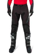 Alpinestars Pro-Dura Pants, Black and Magnet Enduro Pants, worn with a red long-sleeve jersey and black motocross boots, featuring gray Alpinestars branding and durable ripstop construction for off-road riding