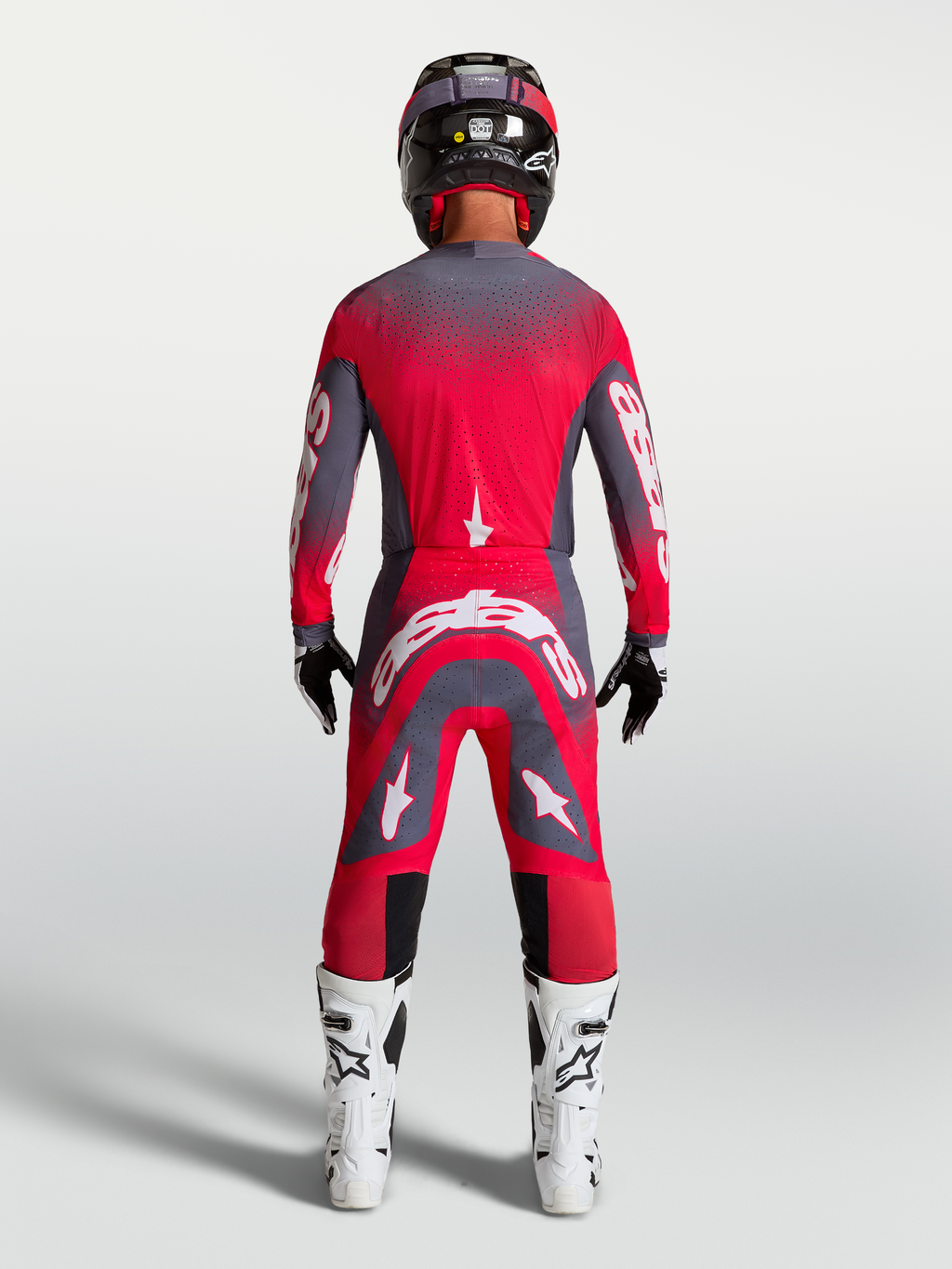Alpinestars Supertech Hiten AFD, zestaw i spodnie motocrossowe, czerwony fluo i szary, widok z tyłu na modelu.