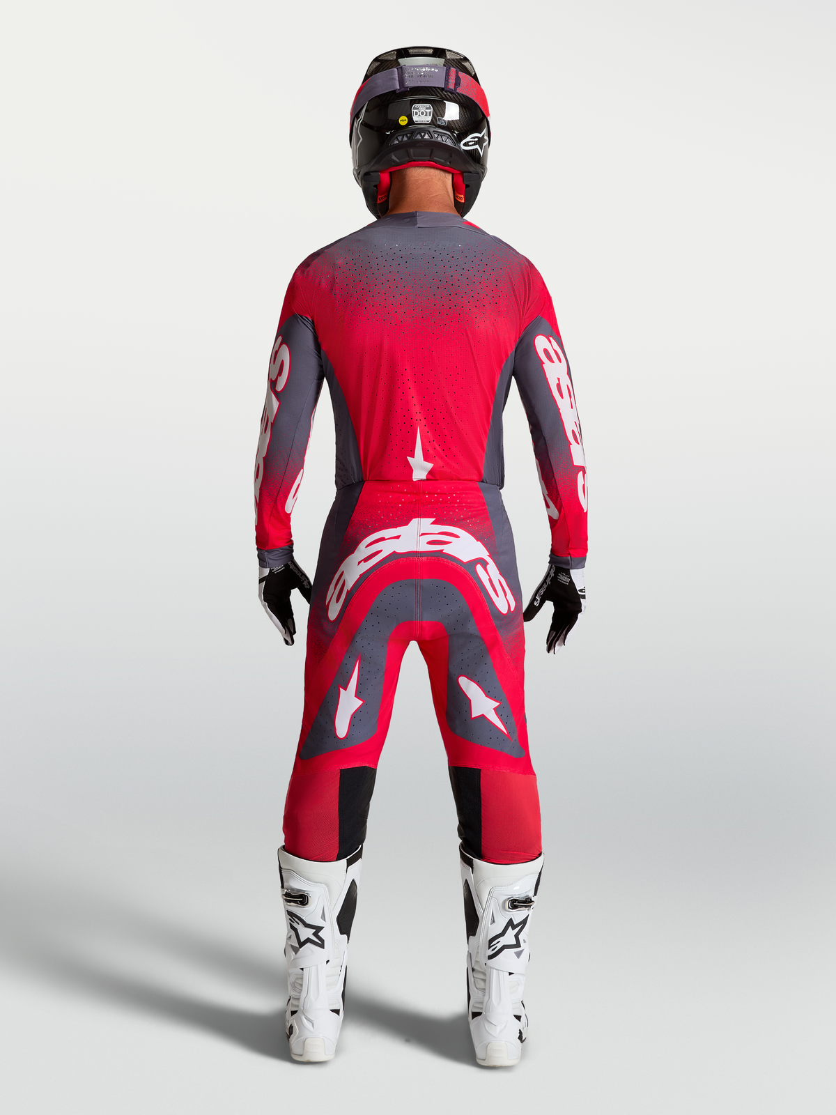 Alpinestars Supertech Hiten AFD, zestaw i spodnie motocrossowe, czerwony fluo i szary, widok z tyłu na modelu.
