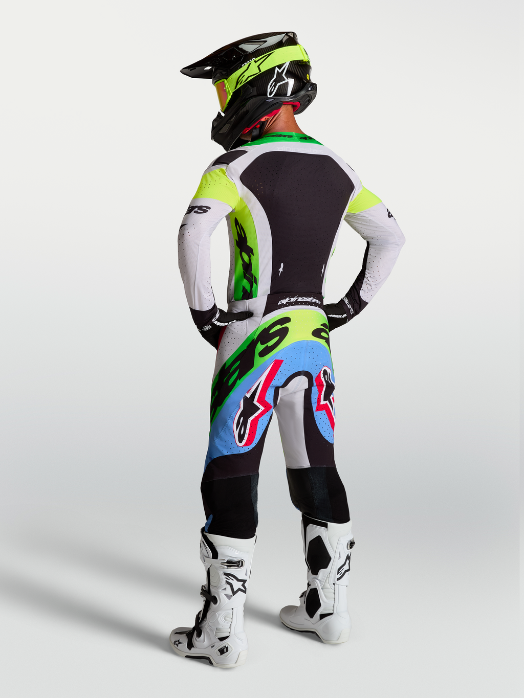 Alpinestars Supertech Dyna, odzież motocrossowa, zielony fluo, czarny i jasny liliowy, spodnie i koszulka, widok z tyłu.