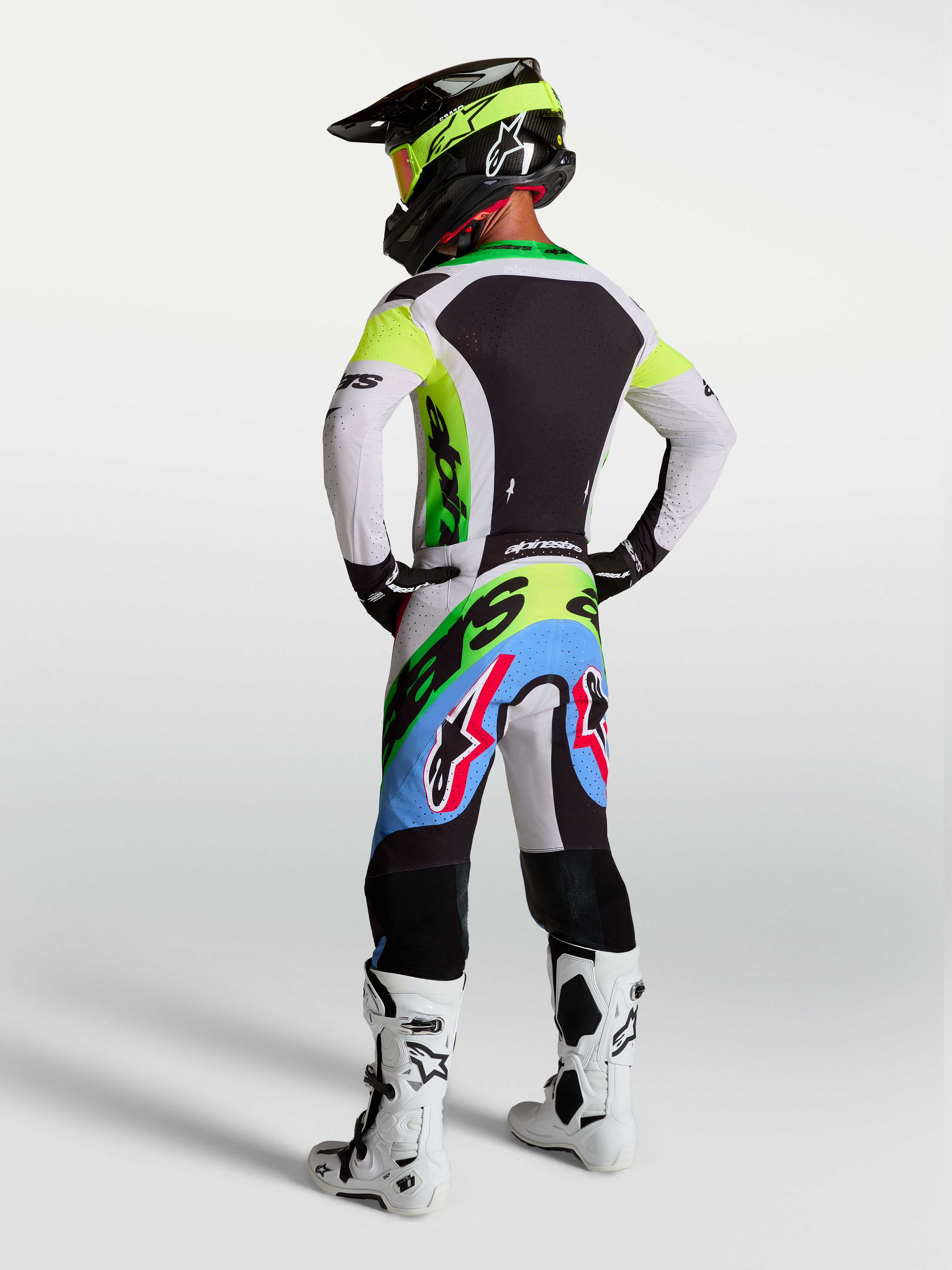 Alpinestars Supertech Dyna, odzież motocrossowa, zielony fluo, czarny i jasny liliowy, spodnie i koszulka, widok z tyłu.