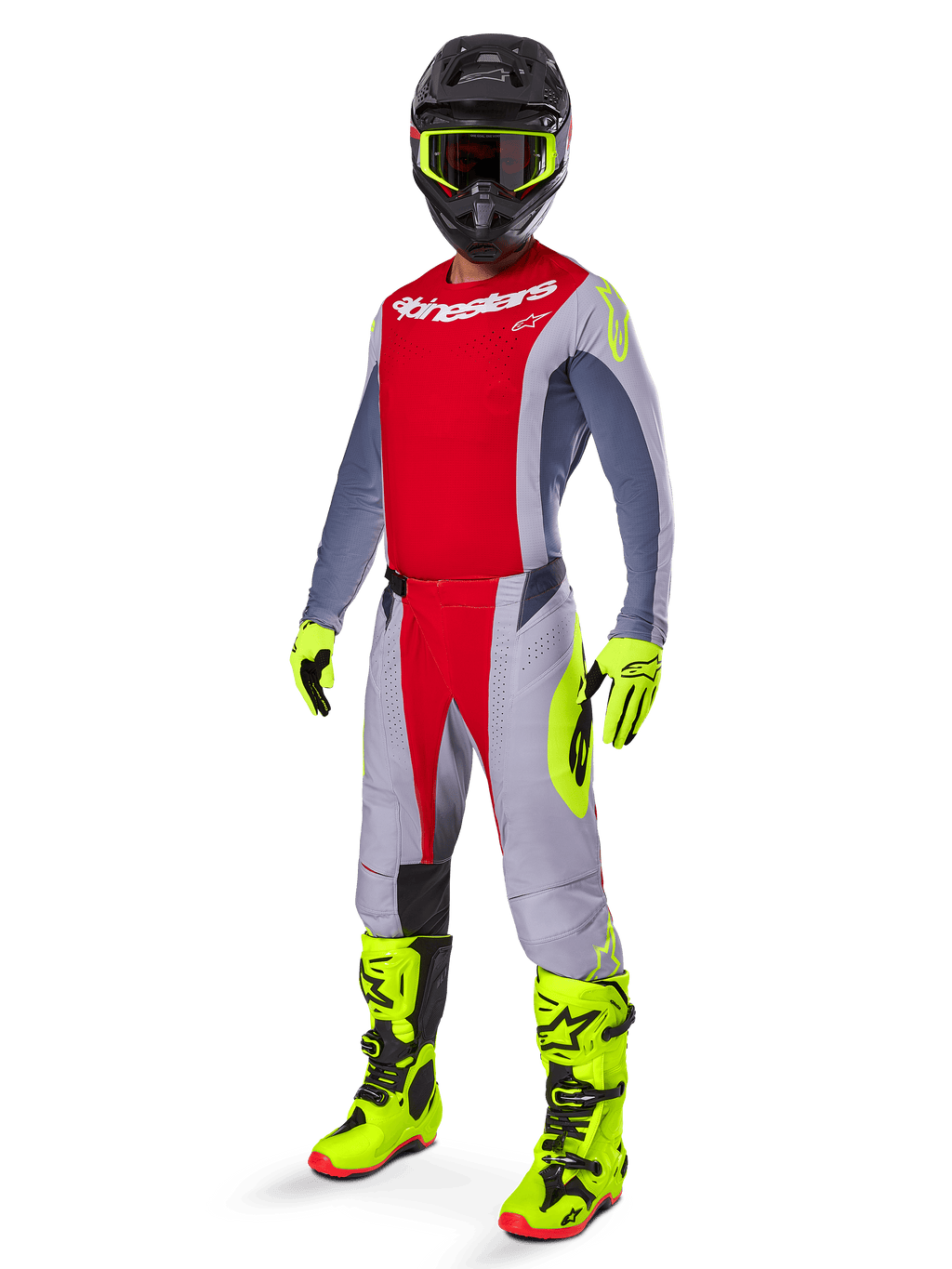 Motocyklista motocrossowy w zestawie Alpinestars 2025 Techstar Melt, czerwono-szara bluza i spodnie, jaskrawożółte neonowe rękawice i buty, czarny kask, kompletny zestaw wyścigowy off-road