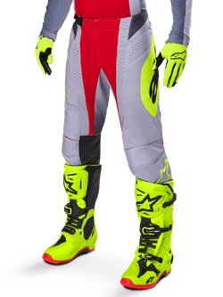 Alpinestars 2025 Techstar Melt Pants, Motocross Pants, Bright Red and Gray, featuring neon yellow side graphics and black knee panels, paired with matching neon yellow boots and gloves, designed for competitive off-road performance