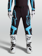Alpinestars Supertech Vesta Pants, pro motocross racing gear, Black and Turquoise with large star graphics and leather knee panels.