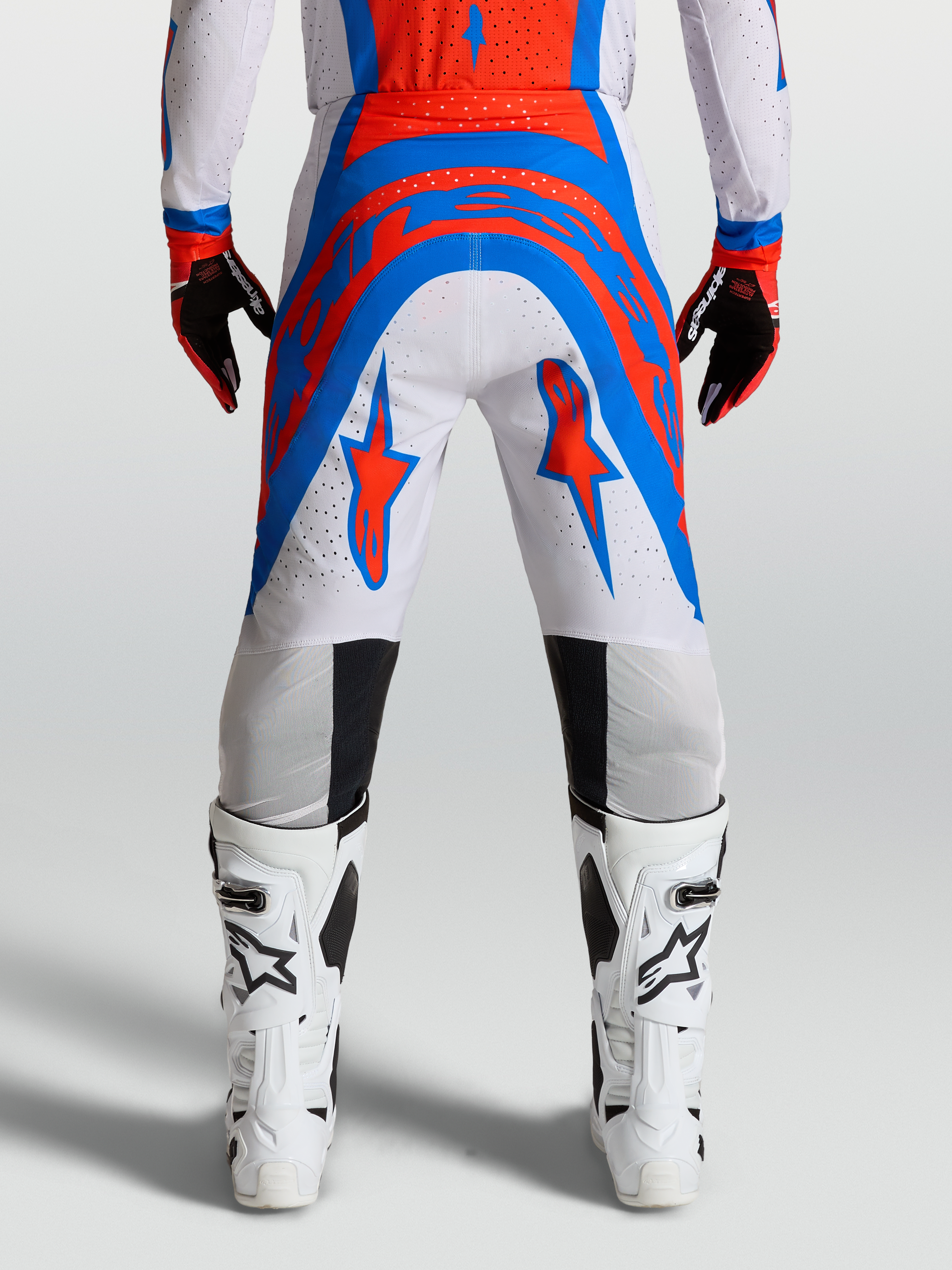 Alpinestars Spodnie Supertech Vesta, spodnie motocrossowe Pro Level, fioletowe i czerwone, sportowy fason wyścigowy z materiału rip-stop.