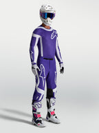 Alpinestars Spodnie Supertech Vesta, profesjonalne spodnie motocrossowe, męskie, ciemnoniebieskie i białe, model w pełnym zestawie wyścigowym, wyczynowy krój sportowy pro level.