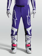 Spodnie Alpinestars Supertech Vesta, niebieskie i białe spodnie motocrossowe o sportowym kroju i konstrukcji rip-stop.