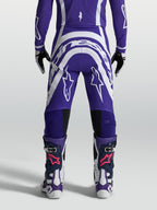 Spodnie Alpinestars Supertech Vesta, męskie spodnie motocrossowe, niebieskie i białe, widok z tyłu, materiał rip-stop.