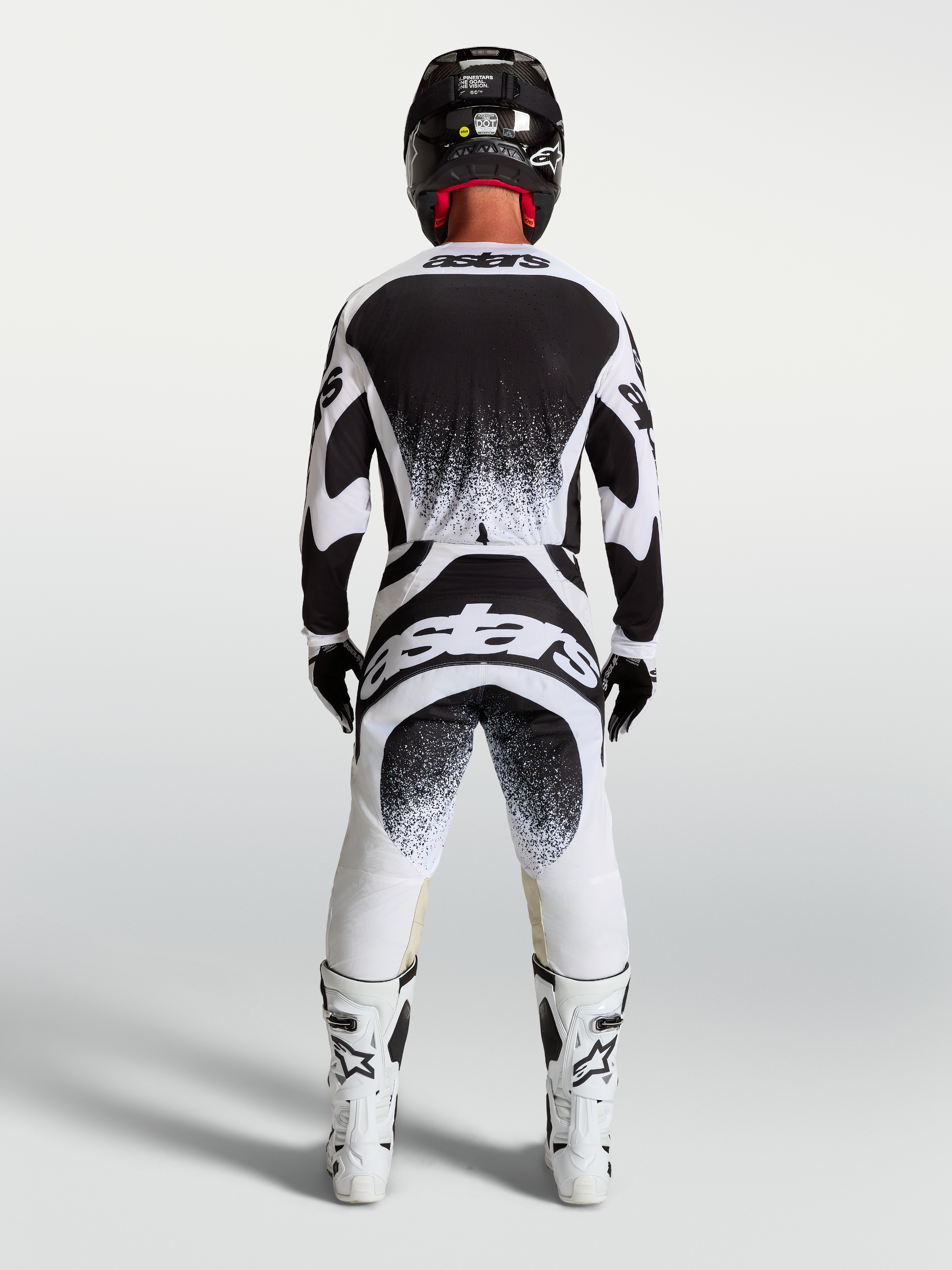 Alpinestars Techstar Swan, męskie spodnie i koszulka motocrossowa, czarne i białe, sportowy krój wyścigowy, widok z tyłu.