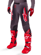 Alpinestars 2025 Supertech Lipan Gear Set, Grey Motocross Pants with bold red and white star logos, paired with bright red performance boots and red and black gloves, designed for pro-level racing