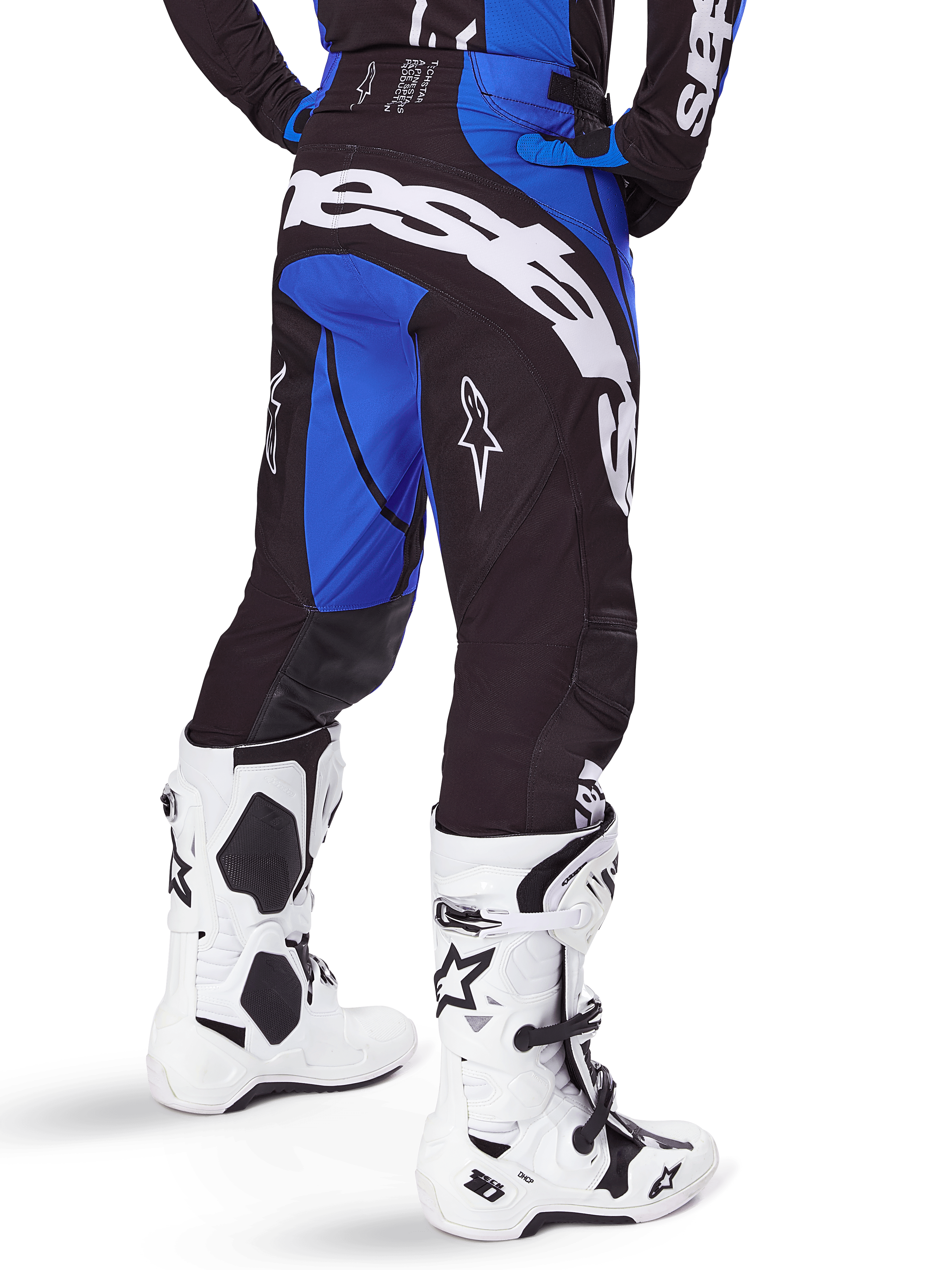 Alpinestars 2025 Techstar Dreem Pants, Motocross Pants, Black and Blue, rear view featuring bold white Alpinestars branding on the seat, worn with white and black motocross boots and matching blue jersey, athletic fit for off-road racing