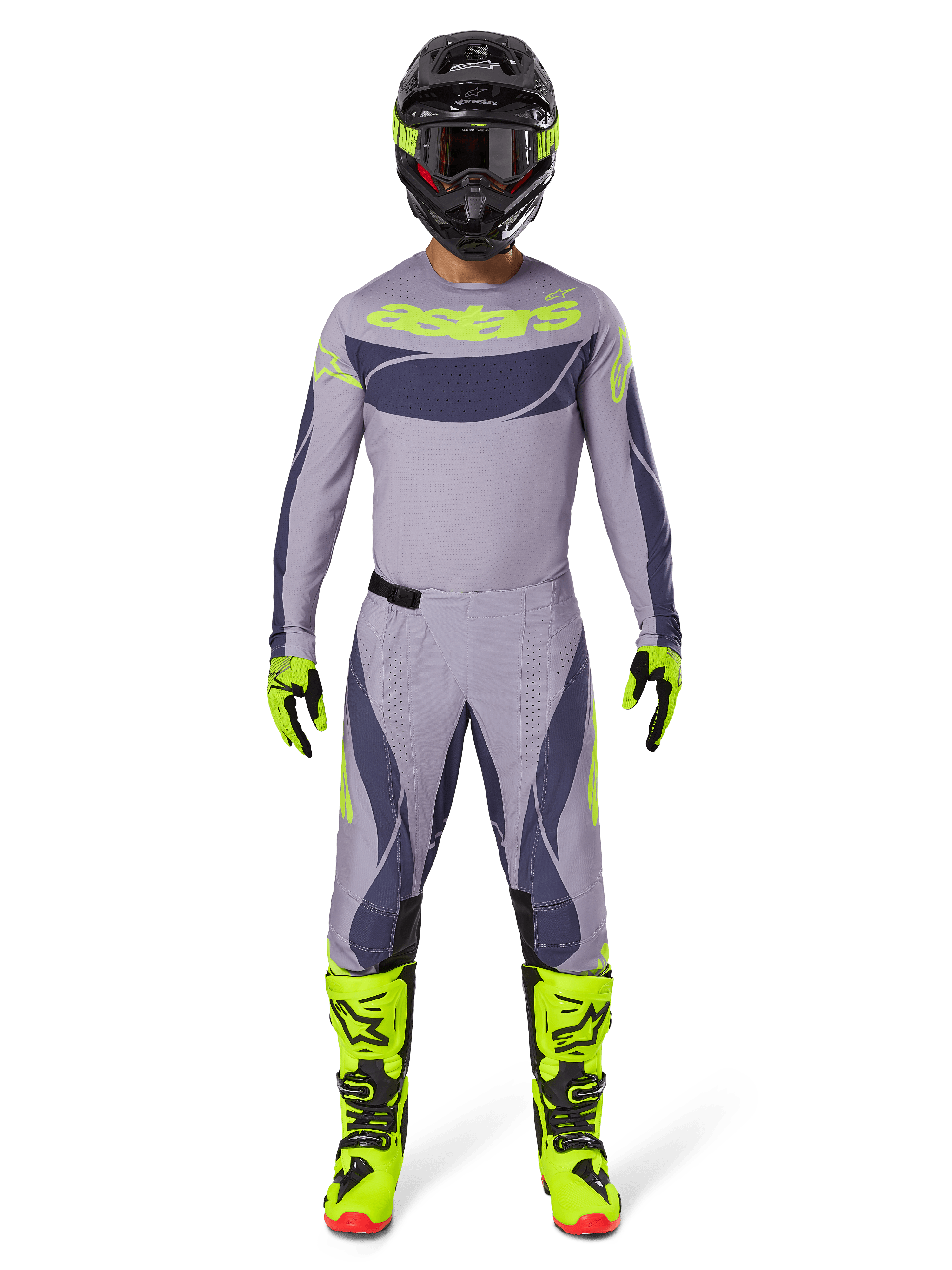 Kierowca motocrossowy w pełnym stroju wyścigowym, spodnie Alpinestars 2025 Techstar Dreem w kolorze szarym i ciemnoszarym, pasująca koszulka z fluorescencyjnym żółtym brandingiem, czarny kask, fluorescencyjne żółte buty i rękawice, dopasowany zestaw wyczynowy do wyścigów terenowych
