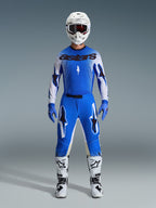 Alpinestars 2026 Supertech Scenz Gear Set, kompletny zestaw motocrossowy, niebieski i biały, strój wyścigowy z niebieską koszulką z czarnym logo „astars”, dopasowane spodnie z grafiką gwiazd, biały kask z ciemnymi goglami, niebieskie rękawice, białe buty z czarnymi akcentami