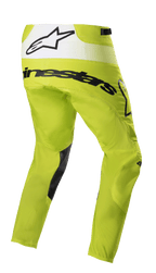 Alpinestars Techstar Push Pants 2023, spodnie motocrossowe, żółte fluo i białe, widok z tyłu pod kątem, czarny branding i biały panel tylny z logo gwiazdy, czarne wstawki po wewnętrznej stronie nogawek, wytrzymała odzież do wyścigów terenowych