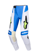 Alpinestars 2026 Techstar Knif Pants, spodnie motocrossowe, kolor niebieski (Ucla Blue), biały i fluorescencyjny żółty, duże czarne logo gwiazdy z neonowymi żółtymi akcentami, branding astars na kolanach, perforowane panele dla wentylacji, sportowy design do wyścigów off-road.