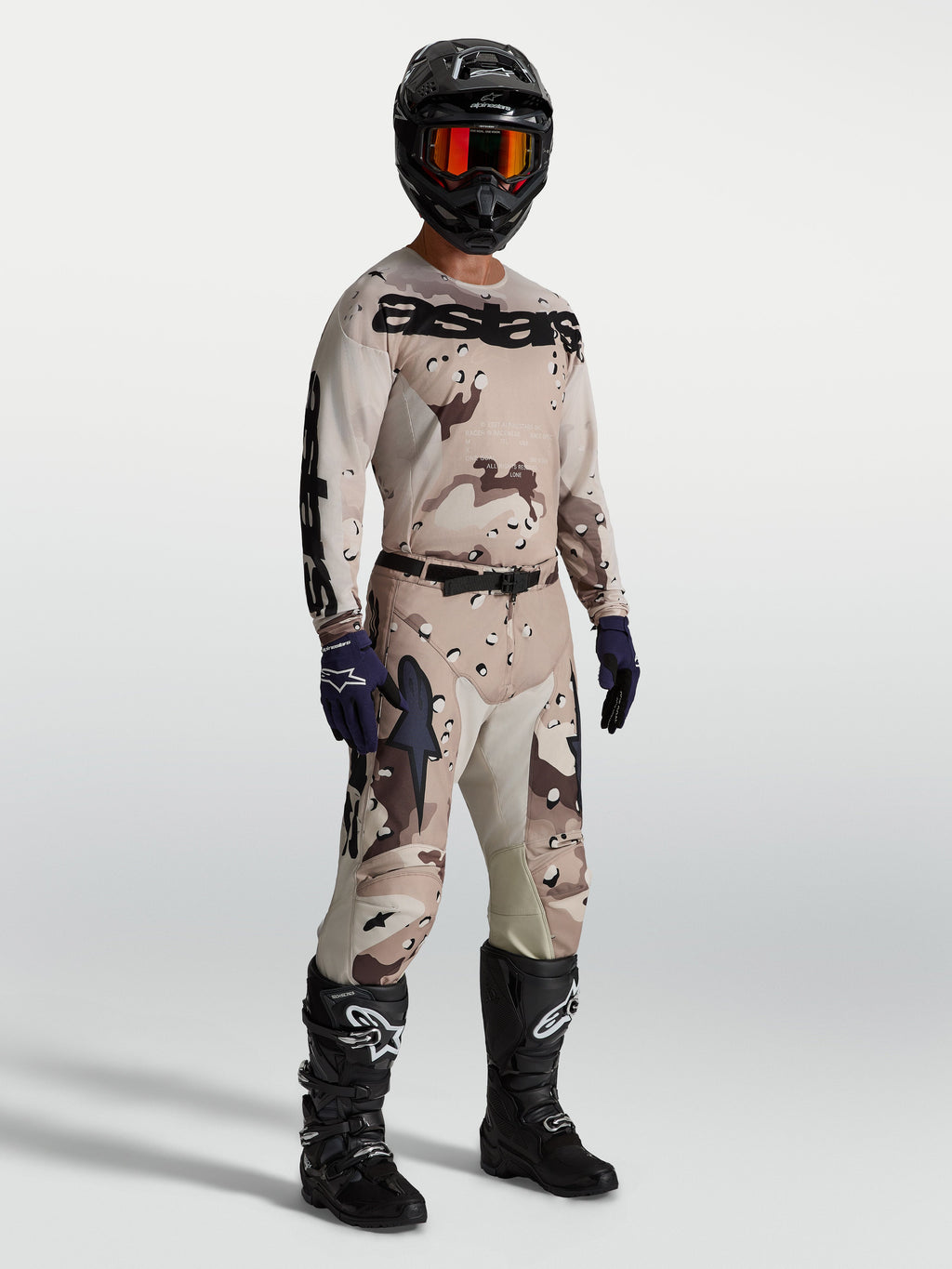 Alpinestars Racer Lone Gear Set, tan and brown camo motocross jersey and pants, with black boots for off-road performance.