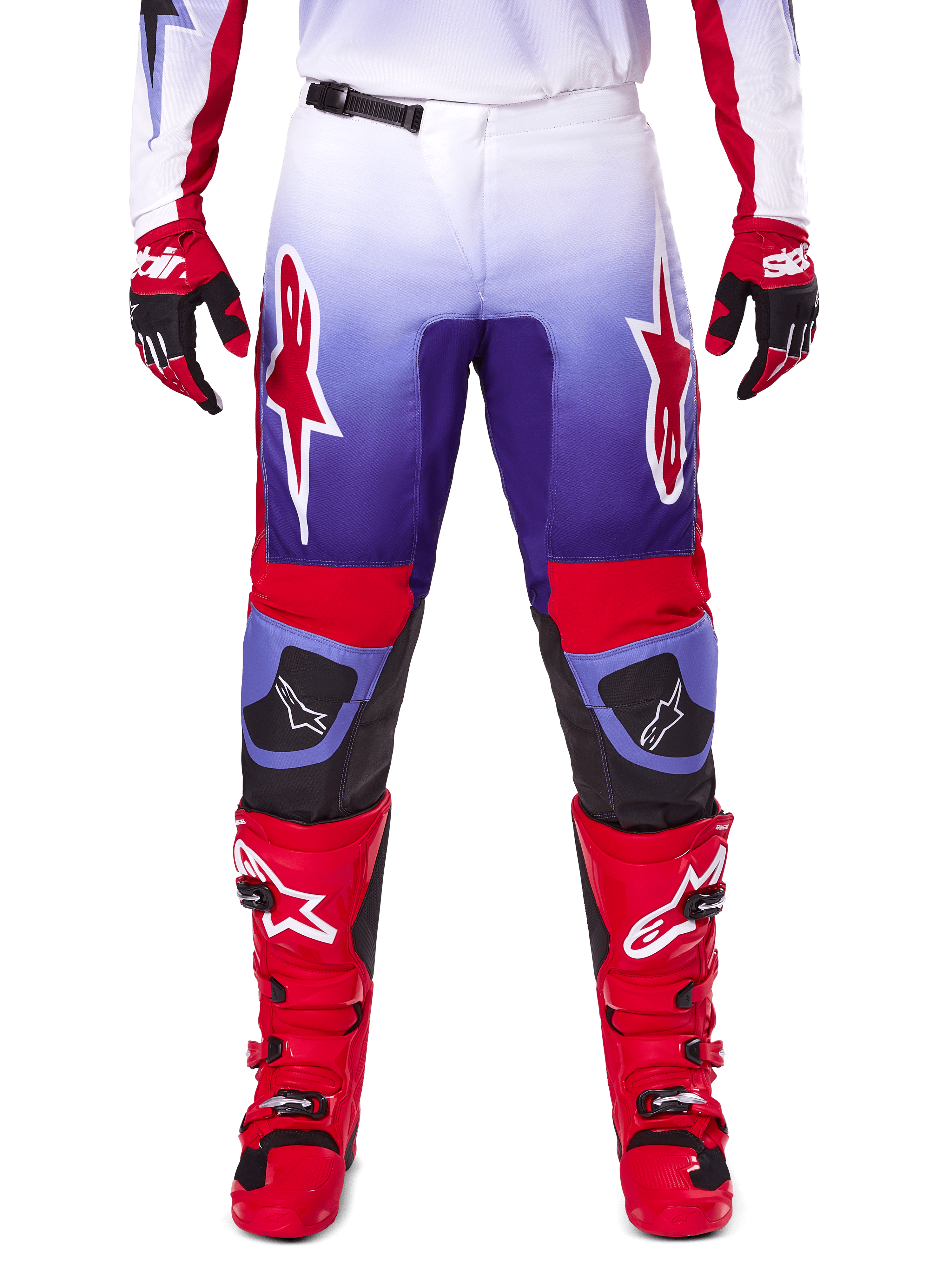 Alpinestars 2025 Fluid Wurx Pants, spodnie motocrossowe, fioletowe i jaskrawoczerwone, noszone z dopasowanymi czerwonymi butami i rękawicami, białe logo na udach i czarne wzmocnienia na kolanach, profesjonalna odzież do jazdy terenowej