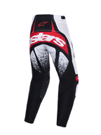 Alpinestars Techstar Nomur Pants 2026, spodnie motocrossowe, czarno-biało-czerwone, widok z tyłu z wyrazistym czerwono-białym brandingiem na siedzeniu, czarno-białe nakrapiane wzory na udach i wielopanelowa konstrukcja wyczynowa.