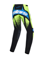 Alpinestars Techstar Nomur Pants 2026, spodnie motocrossowe, ciemnogranatowe, neonowożółte i niebieskie UCLA Blue, widok z tyłu z dużym napisem „astars” na siedzeniu, fluorescencyjne żółte panele z czarną nakrapianą grafiką, wytrzymałe panele do jazdy off-road