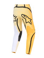 Alpinestars 2026 Fluid Apex Pants, spodnie motocrossowe, żółto-czarne z białymi akcentami, widok z tyłu z wyraźnym czarnym logo Astars, asymetryczny design z wytrzymałymi wzmocnionymi panelami i wstępnie zakrzywionym krojem