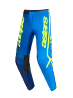 Alpinestars 2026 Fluid Apex Pants, spodnie motocrossowe, niebieskie i żółte neonowe, wyrazisty pionowy żółty branding „astars”, czarne panele na wewnętrznej stronie kolan, ergonomiczna, wstępnie zakrzywiona konstrukcja do jazdy terenowej