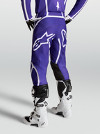 Alpinestars Spodnie Fluid Apex V2, męskie spodnie motocrossowe off-road, niebieskie i białe, z dużym logo gwiazdy z tyłu i ergonomiczną konstrukcją 3D dla pełnej mobilności i komfortu.