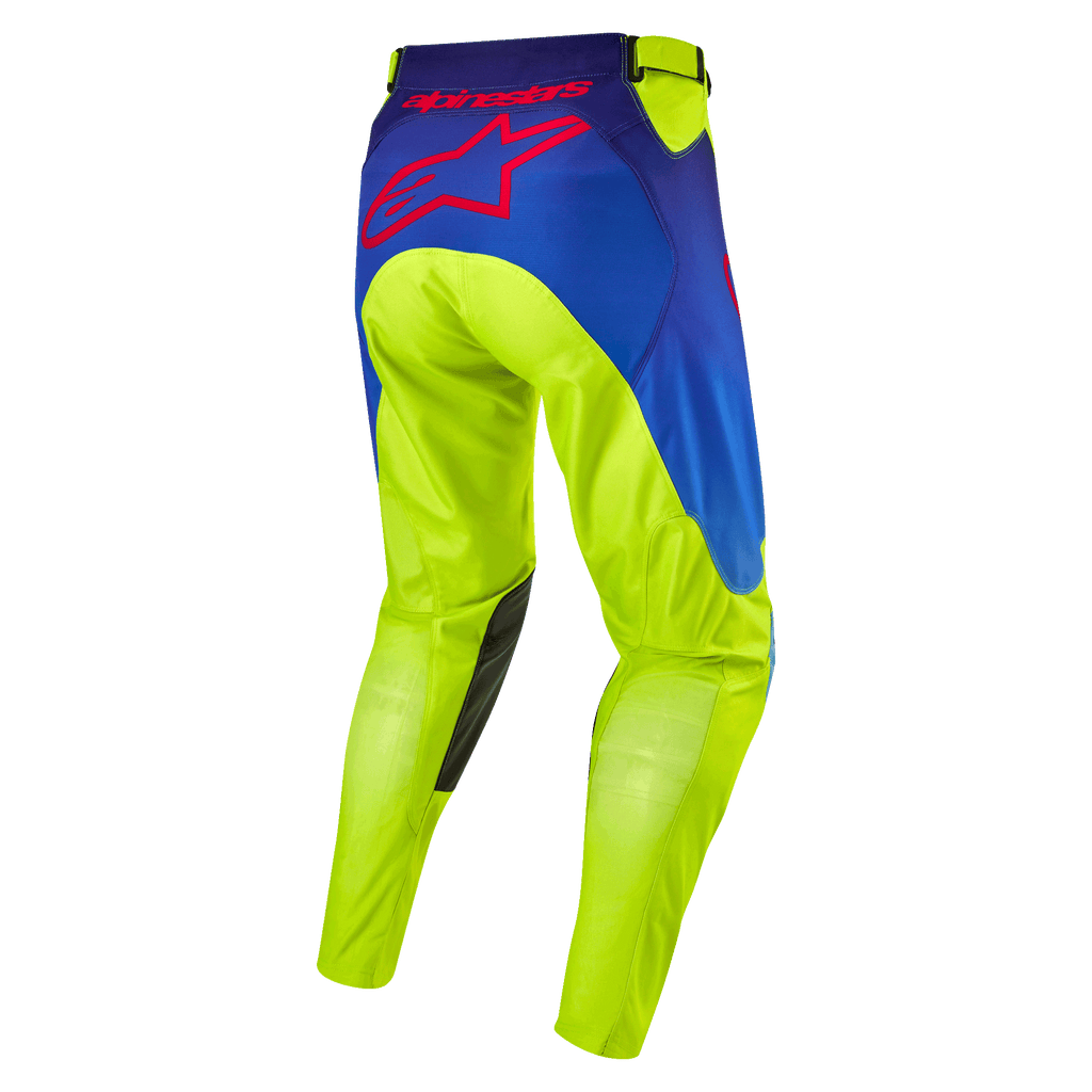 Alpinestars 2024 Racer Hoen Pants, spodnie motocrossowe, żółty neonowy i granatowy, widok z tyłu z dużym czerwonym logo gwiazdy Alpinestars, ciemne skórzane wzmocnienia na kolanach, wytrzymały techniczny materiał do wyścigów terenowych