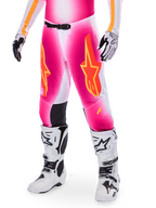 Alpinestars Supertech AFD MIG Limited Edition Motocross Pants, Pink with orange and yellow star logos, worn with white motocross boots and black and white gloves, featuring black inner knee panels and an athletic fit, part of a high-performance racing gear set