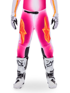 Alpinestars Limited Edition Supertech AFD MIG Pants, Motocross Racing Pants, Pink Fluo and White with Orange accents, featuring large star logos on the thighs, perforated panels, and black knee grip zones, worn with white and black motocross boots