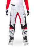 Alpinestars Limited Edition Techstar Deep Pants, Motocross Pants, Black White and High Red, worn with matching red jersey, white and black gloves and boots, featuring white front panels, red inner leg accents, black side panels, Alpinestars logos on thighs, and laser-perforated details for ventilation.