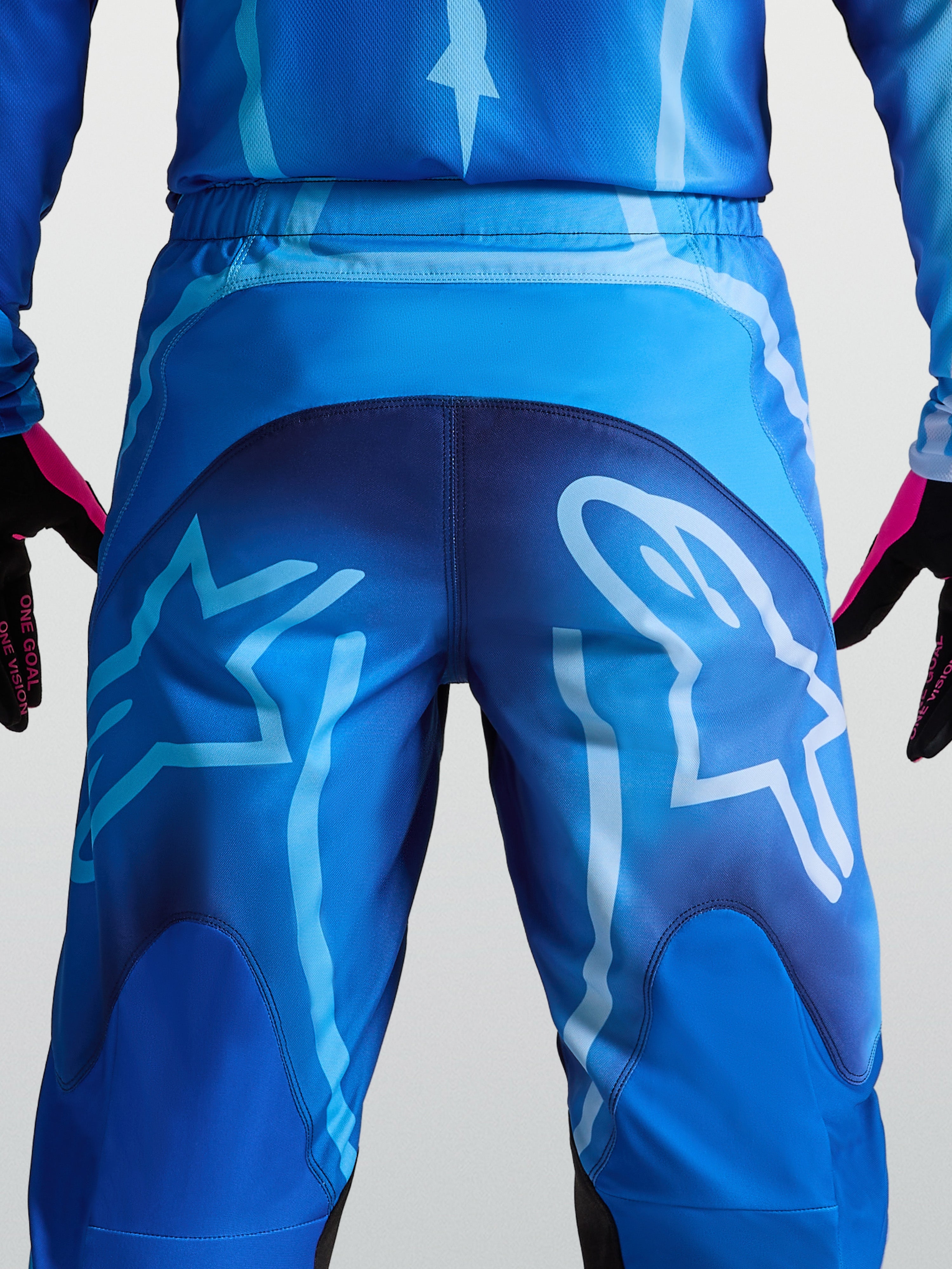 Spodnie Alpinestars Fluid Kepler, niebieskie spodnie motocrossowe, wytrzymały poliester 600D, duża grafika logo z tyłu.