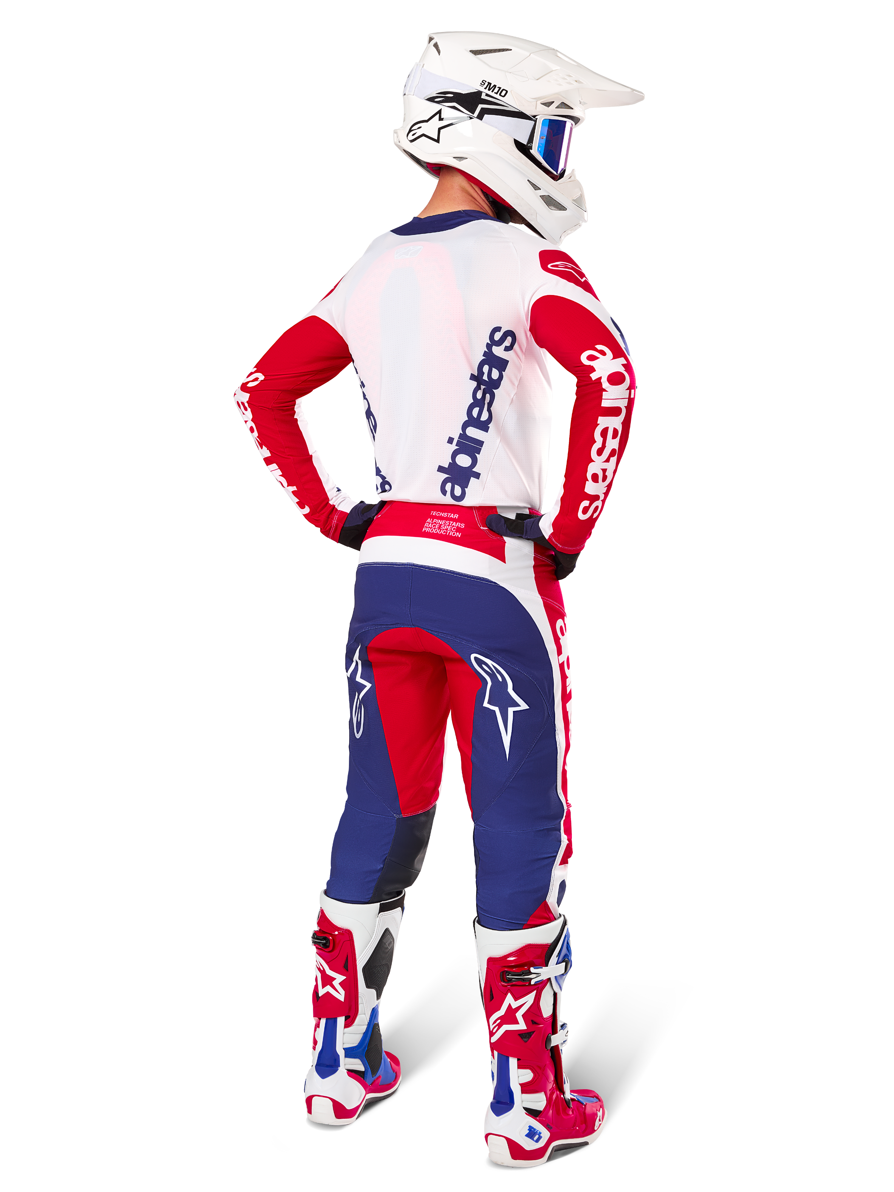 Alpinestars Limited Edition Techstar Fortitude Pants, Motocross Pants, Bright Red White and Blue, shown on a rider from the back with matching jersey, boots, and helmet, highlighting the athletic fit and bold logo placement.