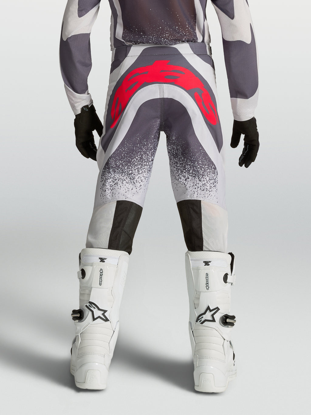Alpinestars Youth Supertech Swan Motocross Pants in Gray and Red Fluo, rear view showing athletic fit and reinforced seat.